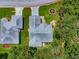 An aerial view of a cozy home with well-maintained landscaping and a driveway surrounded by red at 627 Timbercrest Dr, Leesburg, FL 34748