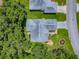An aerial view of a cozy home with well-maintained landscaping and a driveway at 627 Timbercrest Dr, Leesburg, FL 34748
