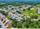 Desirable community aerial view with mature trees, manicured lawns, and a neighborhood golf course at 627 Timbercrest Dr, Leesburg, FL 34748