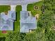 An aerial view of a cozy home with well-maintained landscaping and a driveway at 627 Timbercrest Dr, Leesburg, FL 34748