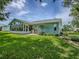 The expansive backyard and well-manicured lawn of this beautifully landscaped residence at 627 Timbercrest Dr, Leesburg, FL 34748
