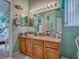 Bright bathroom featuring a granite countertop, cabinets, and updated mirror at 627 Timbercrest Dr, Leesburg, FL 34748