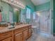 Bright bathroom featuring a granite countertop and updated walk-in shower at 627 Timbercrest Dr, Leesburg, FL 34748