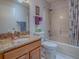 Bathroom featuring a granite vanity and a shower with a patterned curtain at 627 Timbercrest Dr, Leesburg, FL 34748