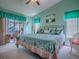 Bright bedroom featuring a large bed, ceiling fan, and view to the outside porch at 627 Timbercrest Dr, Leesburg, FL 34748