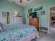 Bright bedroom featuring two dressers, a TV, and an ensuite bathroom at 627 Timbercrest Dr, Leesburg, FL 34748