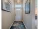 Inviting entryway featuring lovely wall art, light wood floors, and a colorful rug at 627 Timbercrest Dr, Leesburg, FL 34748