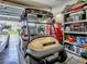 Garage featuring a golf cart, storage shelves, and organized storage solutions at 627 Timbercrest Dr, Leesburg, FL 34748