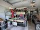 Organized garage featuring a golf cart, car, and storage solutions for efficient space utilization at 627 Timbercrest Dr, Leesburg, FL 34748