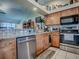 Bright kitchen featuring stainless appliances, granite countertops, and wooden cabinets at 627 Timbercrest Dr, Leesburg, FL 34748