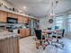 Eat-in kitchen featuring stainless appliances, granite countertops, and wooden cabinets at 627 Timbercrest Dr, Leesburg, FL 34748