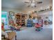 Open living room with multiple seating areas and a view of the kitchen and dining space at 627 Timbercrest Dr, Leesburg, FL 34748