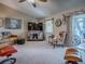 Cozy living room with a comfortable sofa, accent chair, and a sliding glass door at 627 Timbercrest Dr, Leesburg, FL 34748