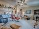 Spacious living room with multiple seating options and a view into the adjacent kitchen at 627 Timbercrest Dr, Leesburg, FL 34748