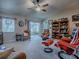 Comfortable living room featuring a ceiling fan, neutral carpet, and a cozy seating arrangement at 627 Timbercrest Dr, Leesburg, FL 34748