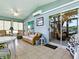Bright sunroom with tile floors, ceiling fan, and sliding glass door at 627 Timbercrest Dr, Leesburg, FL 34748