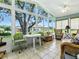 Bright sunroom with tile floors, ceiling fan, and views of the outdoors at 627 Timbercrest Dr, Leesburg, FL 34748