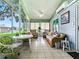 Bright sunroom with tile floors, ceiling fan, and views of the outdoors at 627 Timbercrest Dr, Leesburg, FL 34748