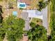 Aerial view showcasing property layout with lush landscaping and a pool at 628 Drew Ave, Clermont, FL 34711