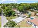 An aerial view of a home and yard showing an in-ground pool, large yard and a long concrete driveway at 628 Drew Ave, Clermont, FL 34711