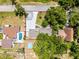Aerial view showcasing property layout with lush landscaping and a pool at 628 Drew Ave, Clermont, FL 34711