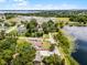 Home with pool near lakeside, framed by trees under blue skies. Red lines show property boundaries at 628 Drew Ave, Clermont, FL 34711