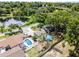 Aerial shot of a home with pool and lush foliage near a tranquil lake, showcasing Florida living at 628 Drew Ave, Clermont, FL 34711