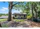View of the backyard of a home with a shed and a shady area in the yard at 628 Drew Ave, Clermont, FL 34711