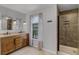 Bathroom boasts double sinks, walk-in shower, and tile flooring at 628 Drew Ave, Clermont, FL 34711