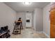 Bonus room with an exercise machine and tile flooring. Perfect space for recreation or fitness at 628 Drew Ave, Clermont, FL 34711