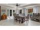 Dining room with large windows, modern chandelier, and a view of the backyard at 628 Drew Ave, Clermont, FL 34711