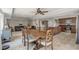 Dining room with large table and chairs, ceiling fan, tile floors and a view of the living room at 628 Drew Ave, Clermont, FL 34711