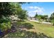 Charming home featuring a sprawling front yard, mature trees, and long driveway leading to a detached garage at 628 Drew Ave, Clermont, FL 34711