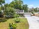 Charming two-story home featuring mature trees, landscaped yard, and long driveway at 628 Drew Ave, Clermont, FL 34711