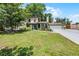 Charming two-story home featuring mature trees, landscaped yard, and attached two car garage at 628 Drew Ave, Clermont, FL 34711