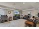 Cozy living room with a large sectional sofa, entertainment center, and stylish decor at 628 Drew Ave, Clermont, FL 34711