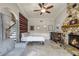 Spacious living room with a stone fireplace, tile flooring, and a staircase in view at 628 Drew Ave, Clermont, FL 34711