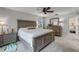 Comfortable bedroom features a queen size bed, carpeted floors and natural lighting at 628 Drew Ave, Clermont, FL 34711