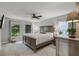 Serene bedroom featuring a large bed, natural light and carpeted floors at 628 Drew Ave, Clermont, FL 34711