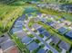 Aerial shot of home situated near a golf course, lake and other homes in the community at 6295 Danielson Loop, The Villages, FL 32163