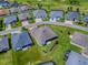 Aerial view of the property surrounded by lush landscaping and neighboring houses at 6295 Danielson Loop, The Villages, FL 32163
