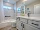 Bright bathroom featuring quartz countertop, modern faucet, tub-shower combo, and sleek fixtures at 6295 Danielson Loop, The Villages, FL 32163