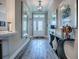 Elegant foyer features wood-look flooring, high ceilings, and decorative mirrors and accents at 6295 Danielson Loop, The Villages, FL 32163