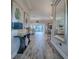 Inviting hallway with wood-look flooring, stylish console table, and views into the living areas at 6295 Danielson Loop, The Villages, FL 32163