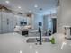 This kitchen features a stainless steel sink, white countertops and cabinets, and stainless steel appliances at 6295 Danielson Loop, The Villages, FL 32163