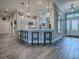 Open-concept kitchen with a breakfast bar, pendant lighting, white cabinetry, and modern finishes at 6295 Danielson Loop, The Villages, FL 32163