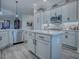 A spacious open kitchen offers stainless steel appliances, white countertops, and a center island at 6295 Danielson Loop, The Villages, FL 32163