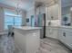 This bright, airy kitchen boasts stainless steel appliances, an island, and an eat-in breakfast nook at 6295 Danielson Loop, The Villages, FL 32163