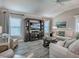 Comfortable living room features a built-in entertainment center, plush seating, and lots of natural light at 6295 Danielson Loop, The Villages, FL 32163