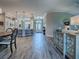 Open floor plan showcasing the kitchen, foyer, and living areas with continuous wood-look flooring at 6295 Danielson Loop, The Villages, FL 32163
